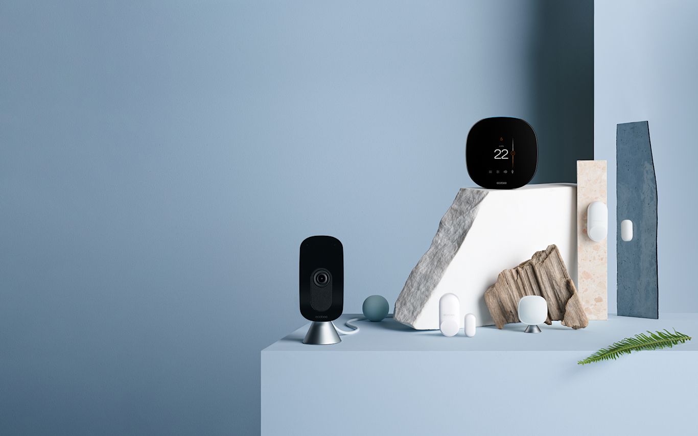 ecobee SmartCamera, SmartThermostat with voice control, and sensors on a blue background.