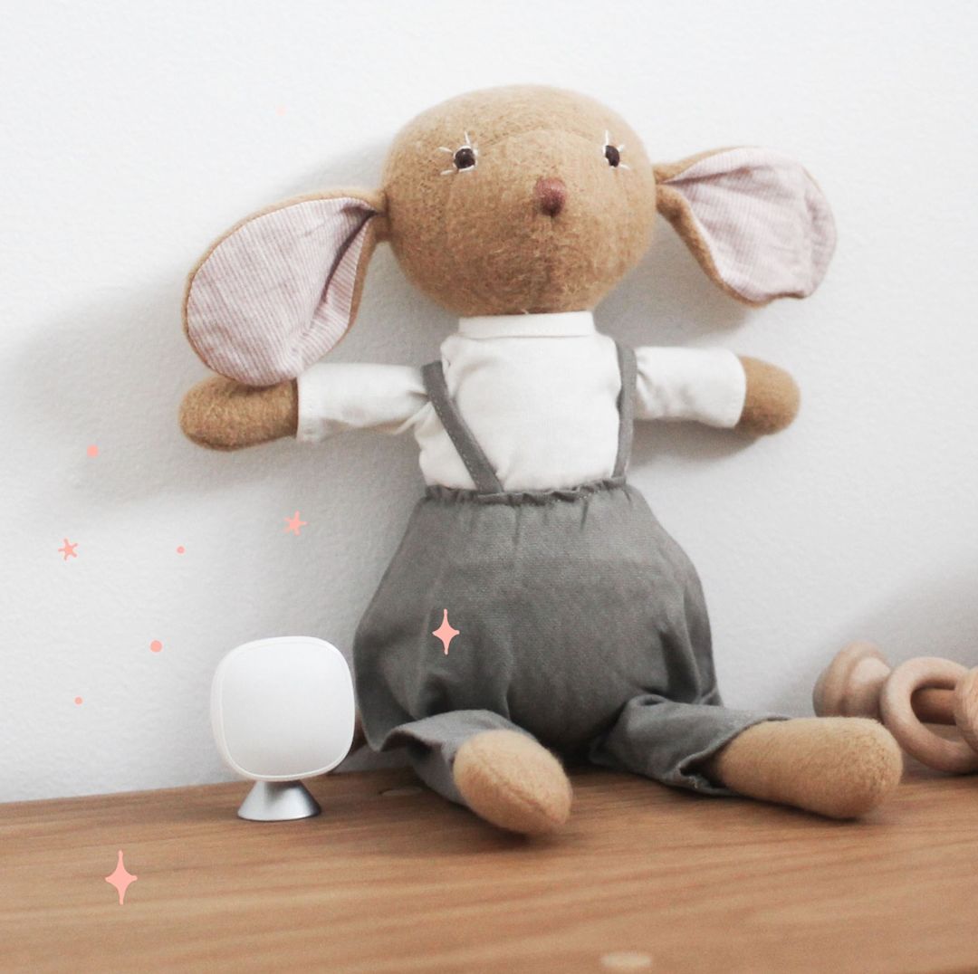 An ecobee SmartSensor sits next to a toy rabbit.