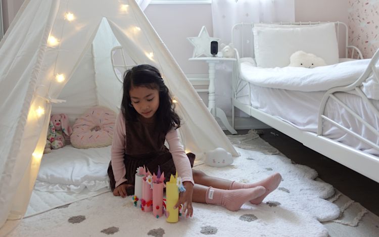 A little girl plays in her room while the ecobee SmartCamera looks on.