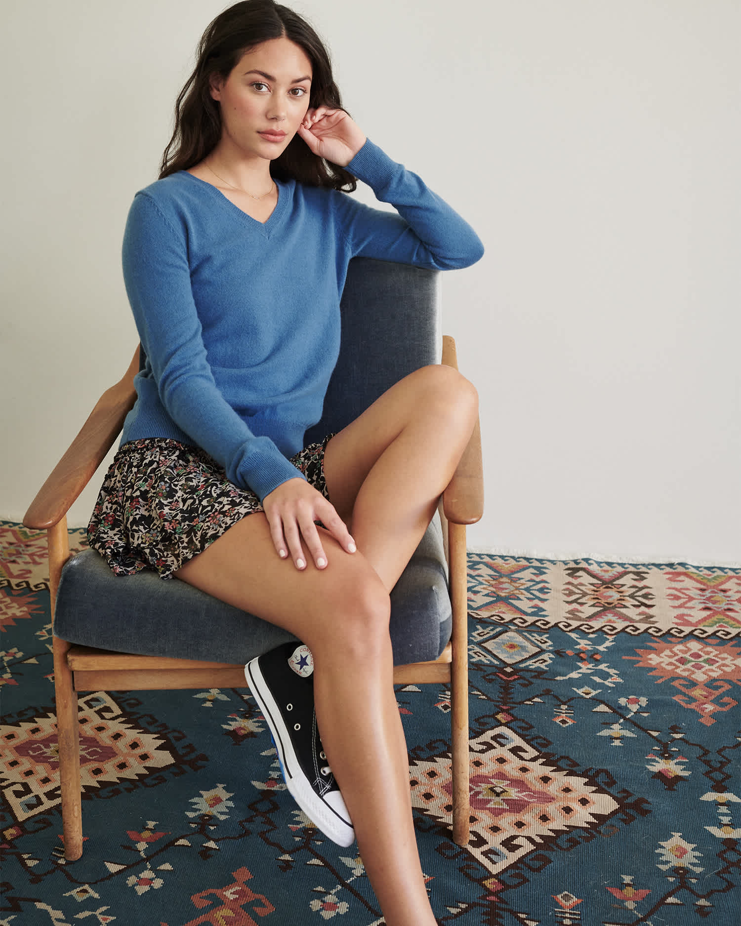 blue cashmere v-neck sweater women sitting