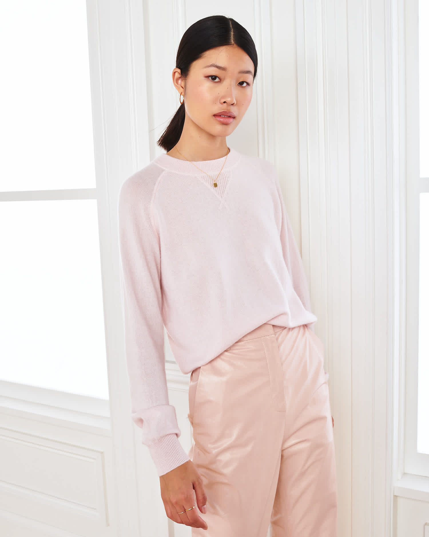 pink cashmere sweatshirt for women standing