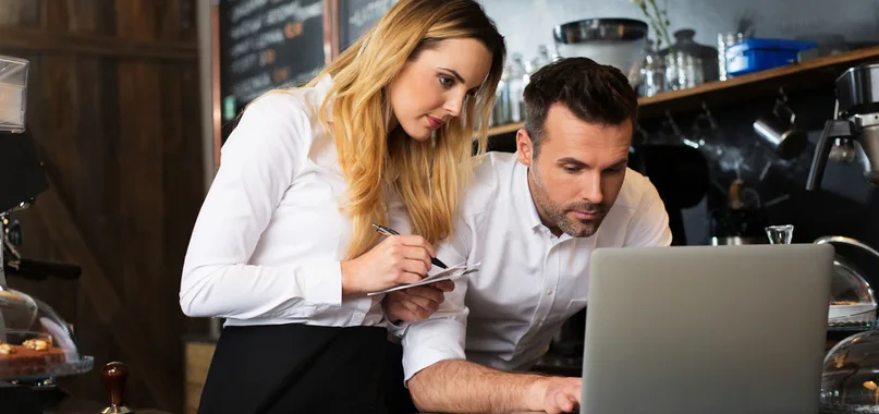 Two people working on laptop 