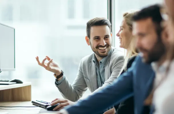 Office workers laughing while they work