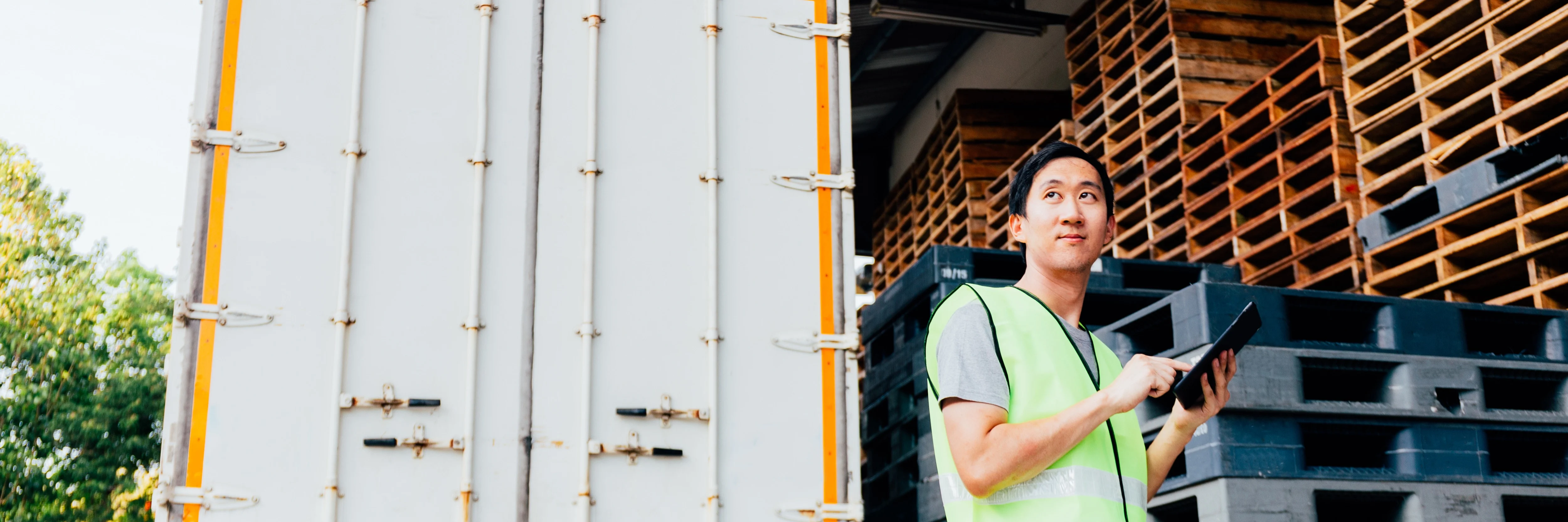 Man reviewing inventory on an iPad, before it gets loaded onto the delivery truck.