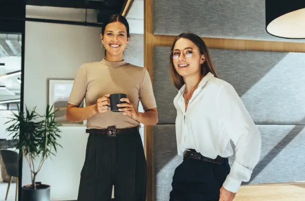 Smiling corporate employees in sleek, modern office