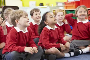 Primary school children sat on the floor for assembly