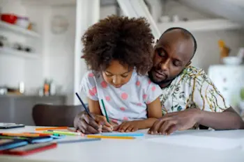 Father and child working on homework together