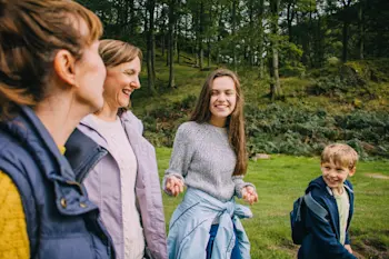 Parents with their children in the woods on a walk