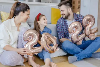 Family holding 2022 balloons