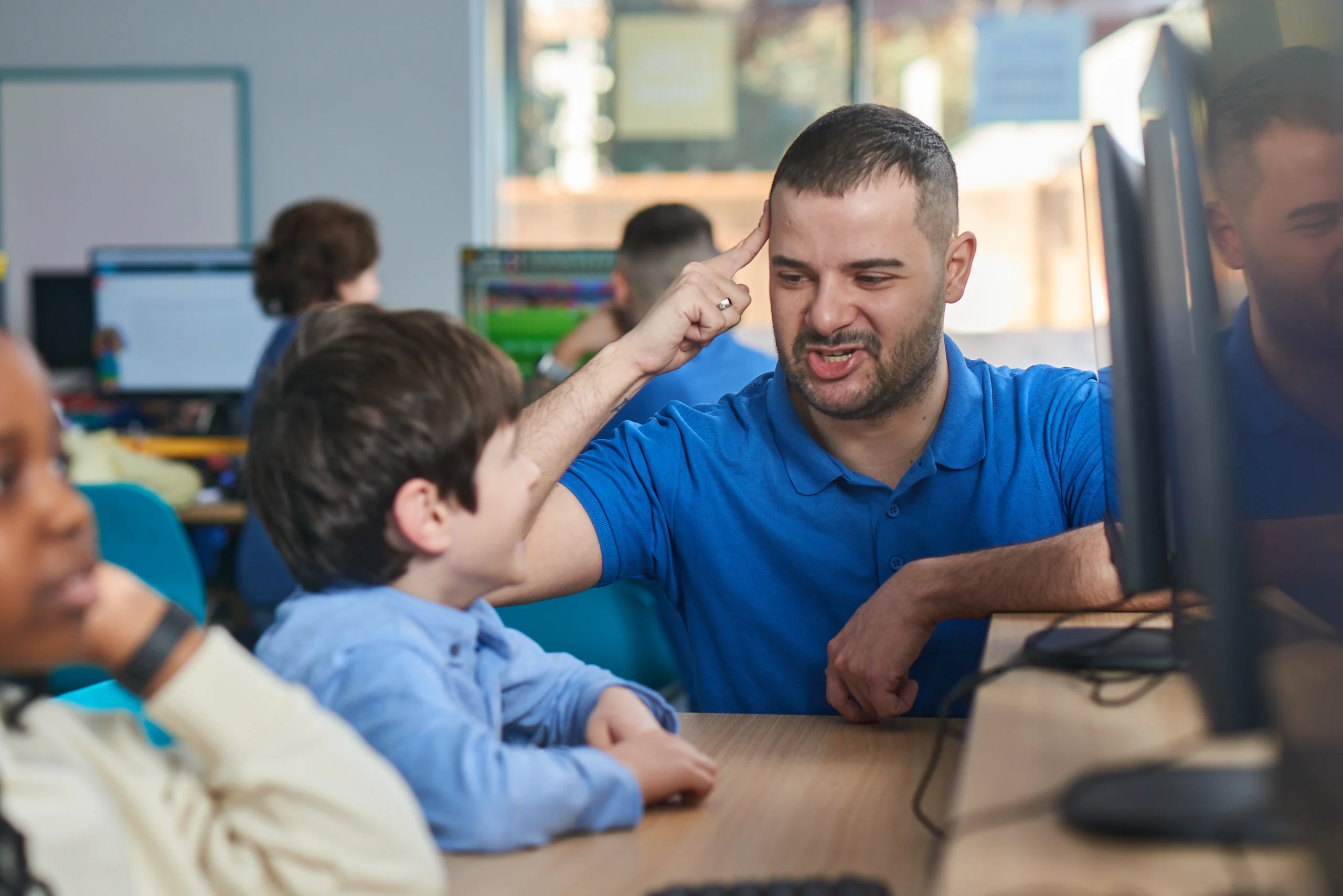 Tutor helping a SEND child learn in an Explore Learning centre