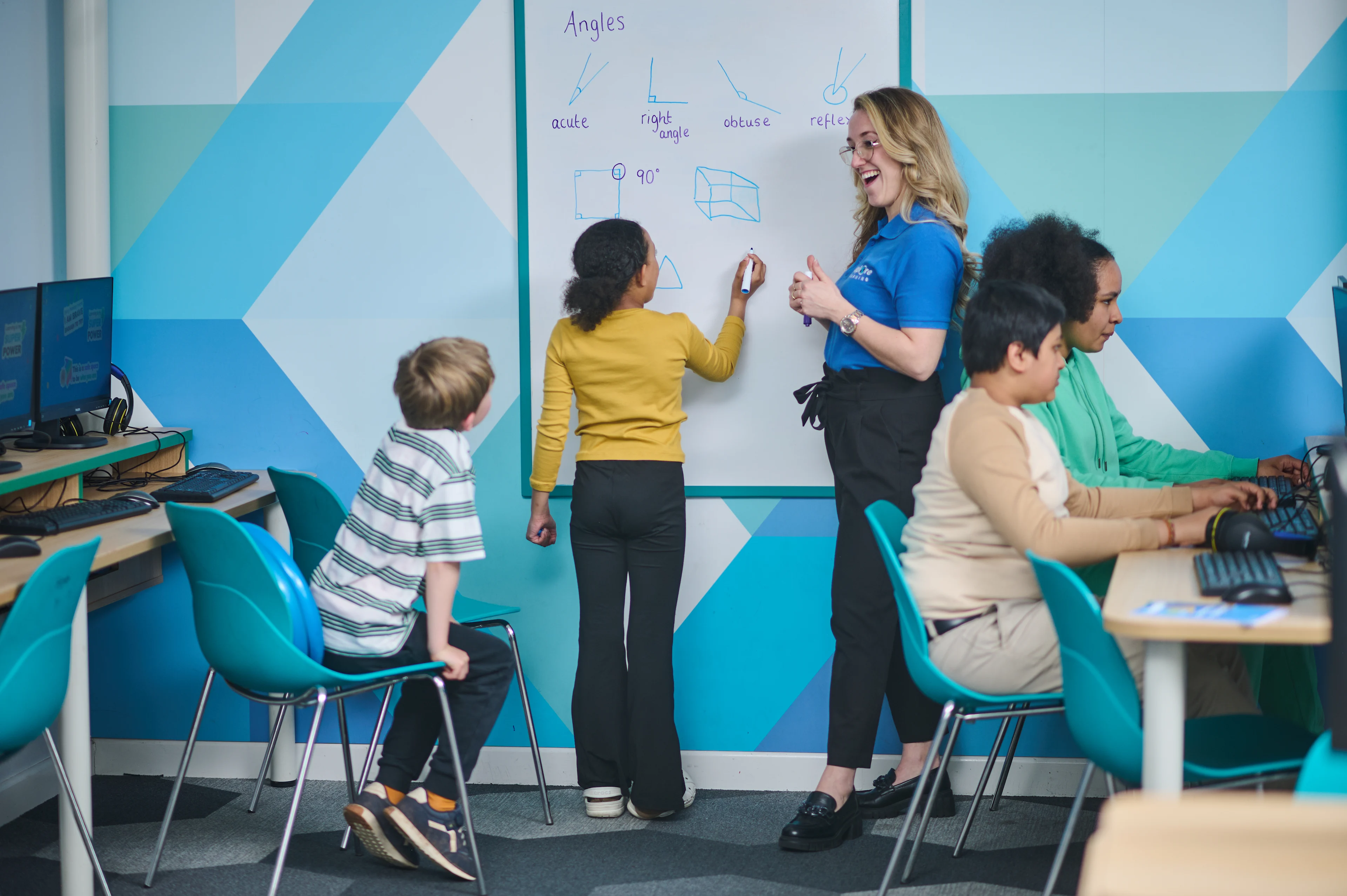 Tutor teaching a small group in an Explore Learning centre