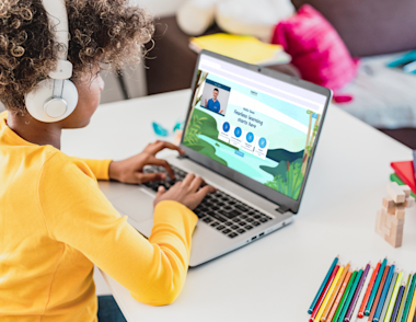 Young girl taking part in an online tuition session with an Explore Learning tutor using our smart learning tool.