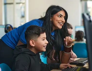 A female Explore Learning tutor works with a young boy to support him in preparing for 11 plus and entrance exams.