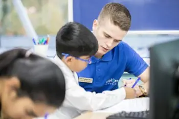 Tutor working with a child on their worksheet