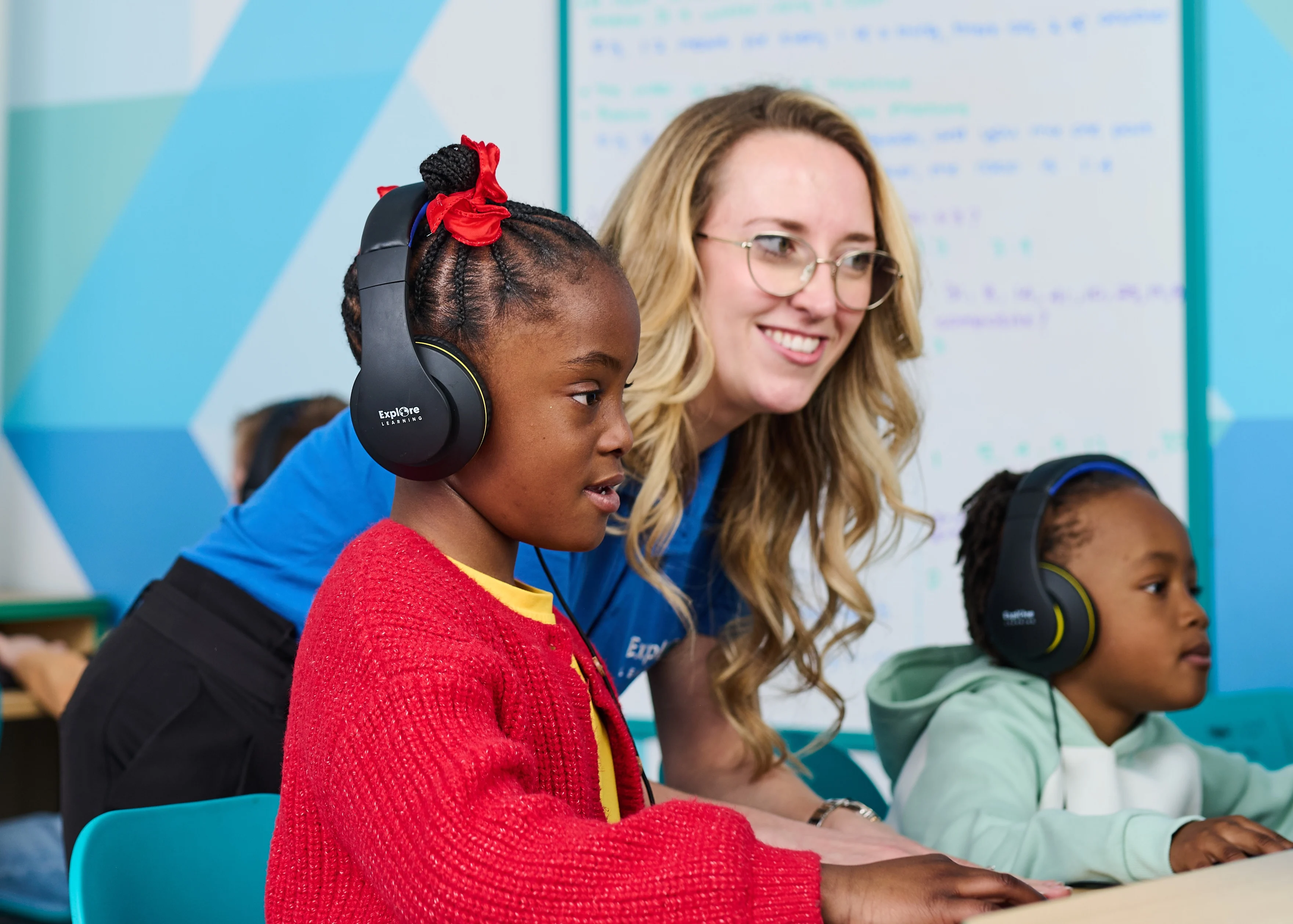 Tutor helping child in an Explore Learning centre