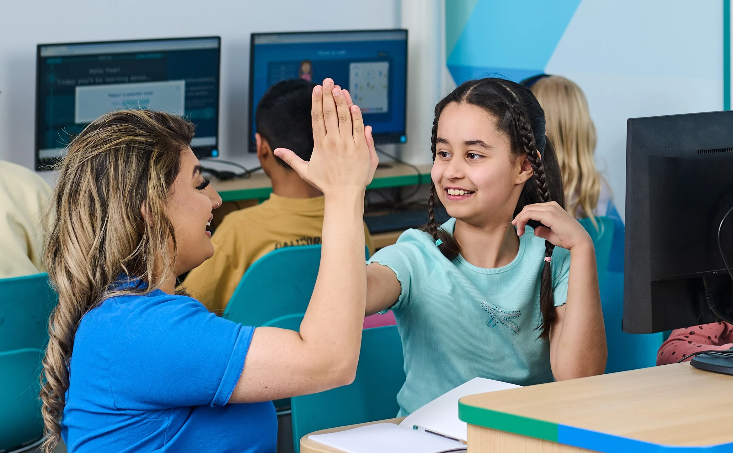 SEND in-centre tuition, child high-fiving tutor