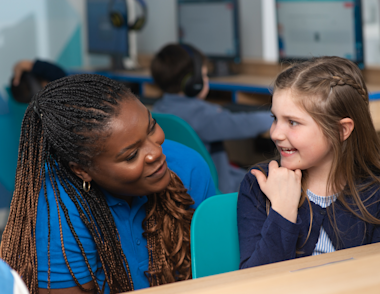 Young girl smiling in a free trial with an Explore Learning tutor.