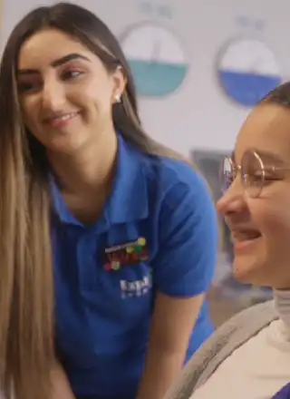 Explore Learning member Kyara works with their Tutor in a learning centre.
