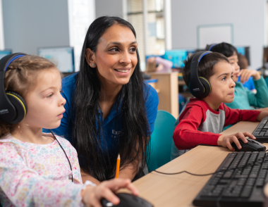 A tutor assists a child with their work.