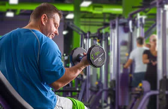 Man lifting weights at YouFit Health Clubs