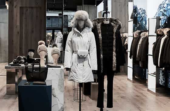 Inside of a Mackage store displaying sorted winter jackets and hats 
