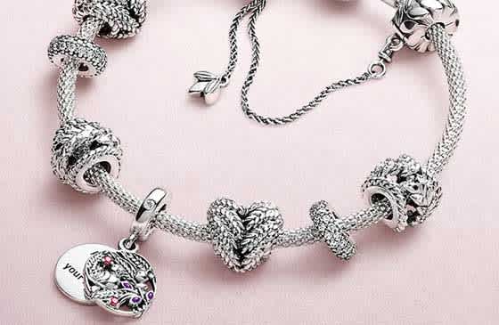 Pandora charm bracelet on pink felt surface 