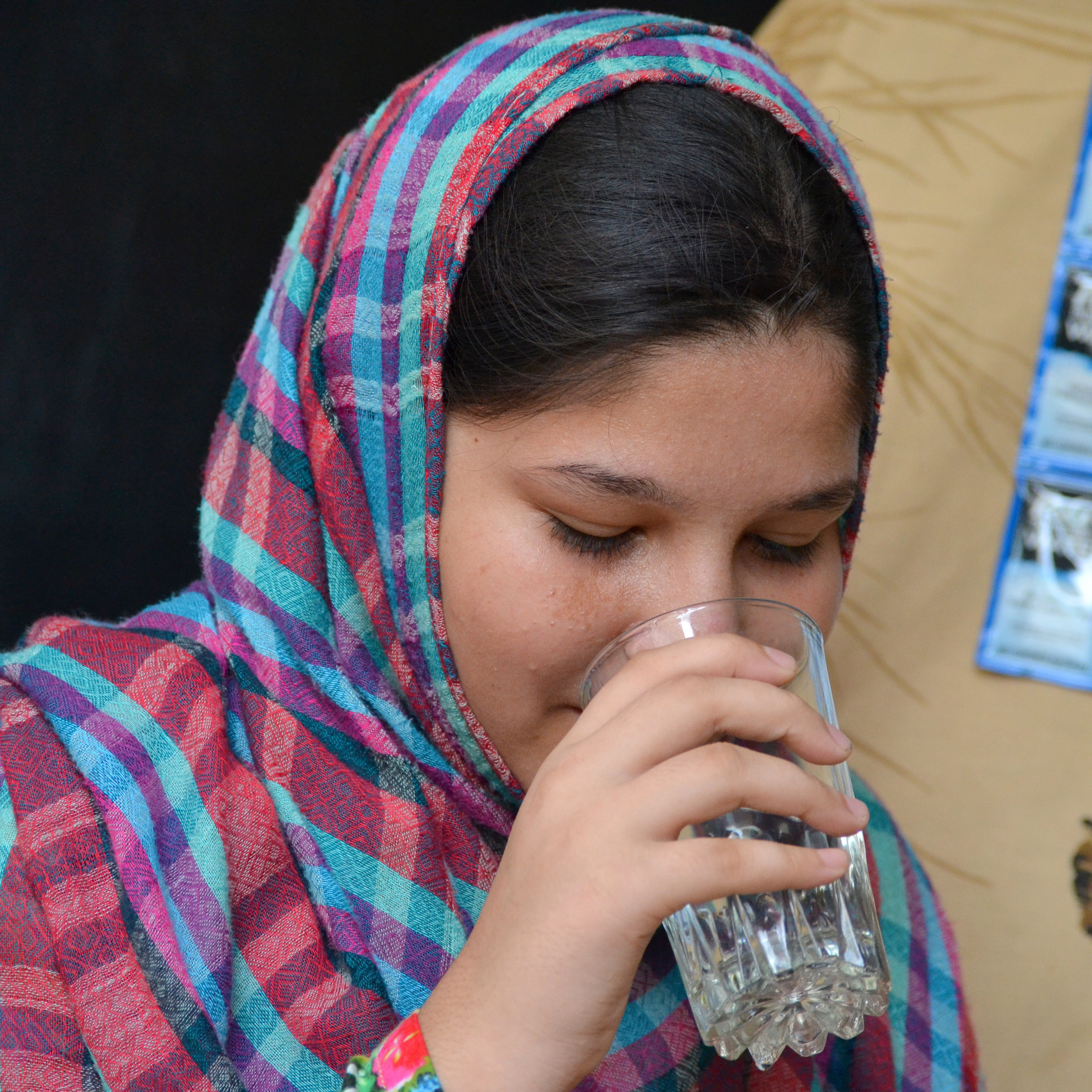 Children are smiling and drinking water