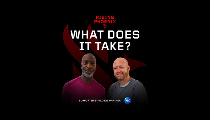 Two men smile and stand together. Red and white text above their heads says, 'Rising Phoenix. What Does It Take?'