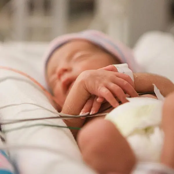 Newborn child with Pampers Preemie