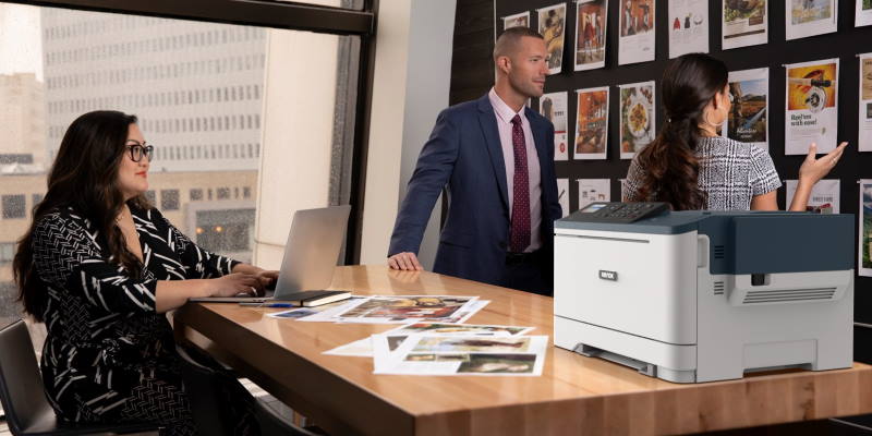 C310 on  table with people looking at print samples