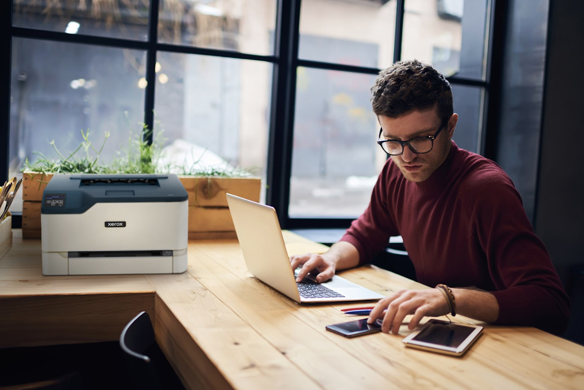 C230 on desk with man using laptop