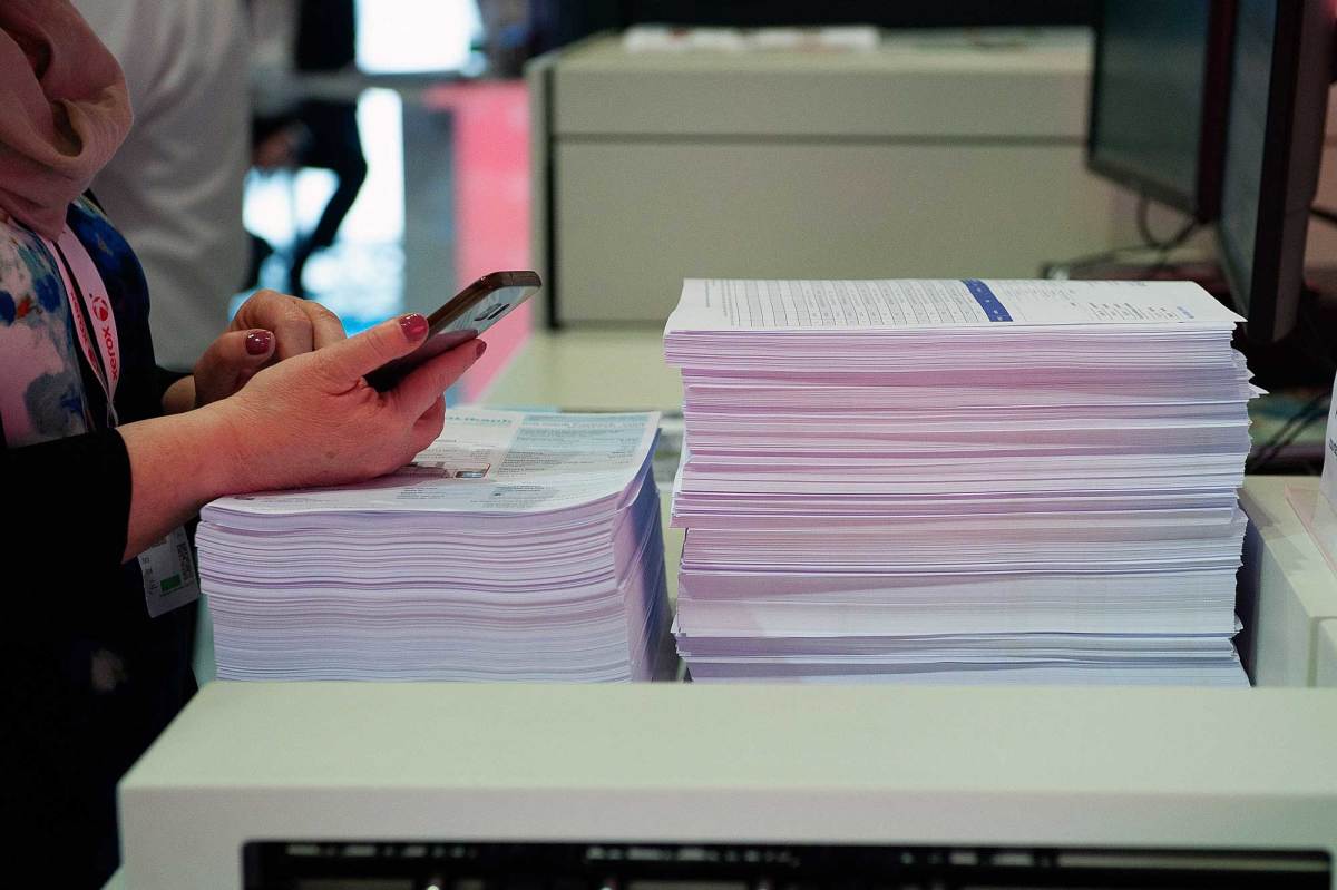 Smartphone and stacks of paper