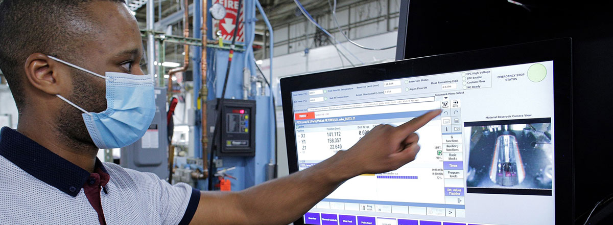 Man using touchscreen monitor in a warehouse