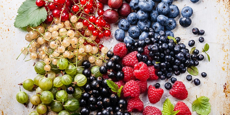Various colourful berries laying on a table