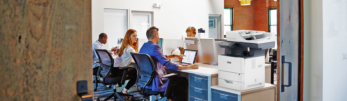People working in an office with a Xerox VersaLink B625 MFP