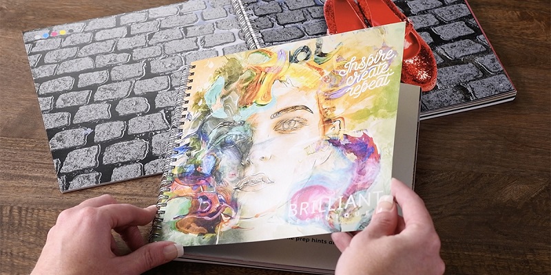 Spiral bound books with brightly colored pages and covers