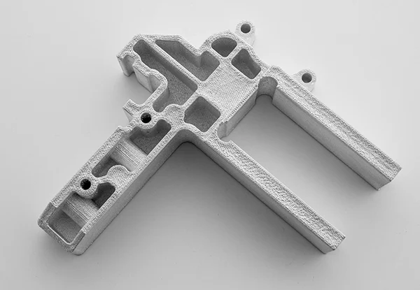The bracket for the iGen® 5 printed in aluminum 4008 using the Xerox® ElemX™ Liquid Metal Printer