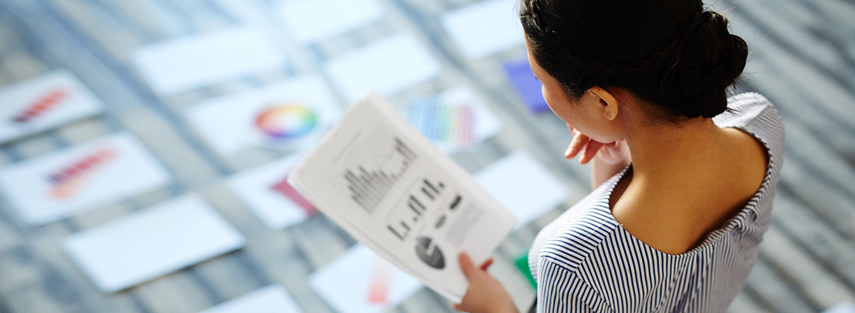 View from above a woman who is looking at a printed chart