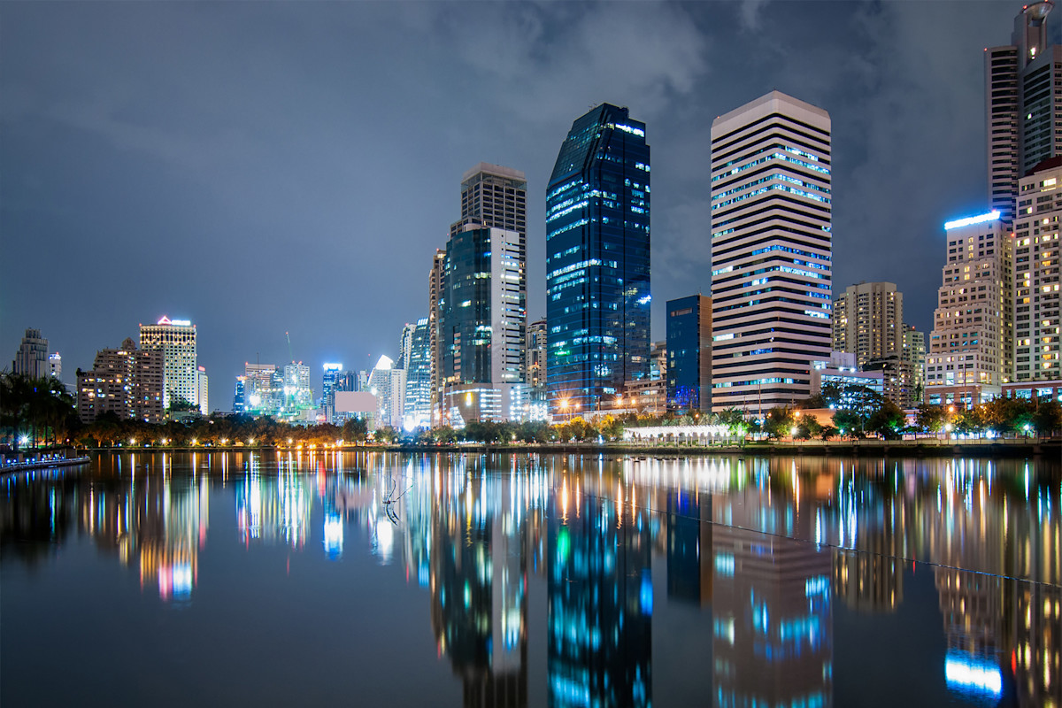 City skyline at night, reflected on water