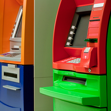 Two brightly colored ATMs
