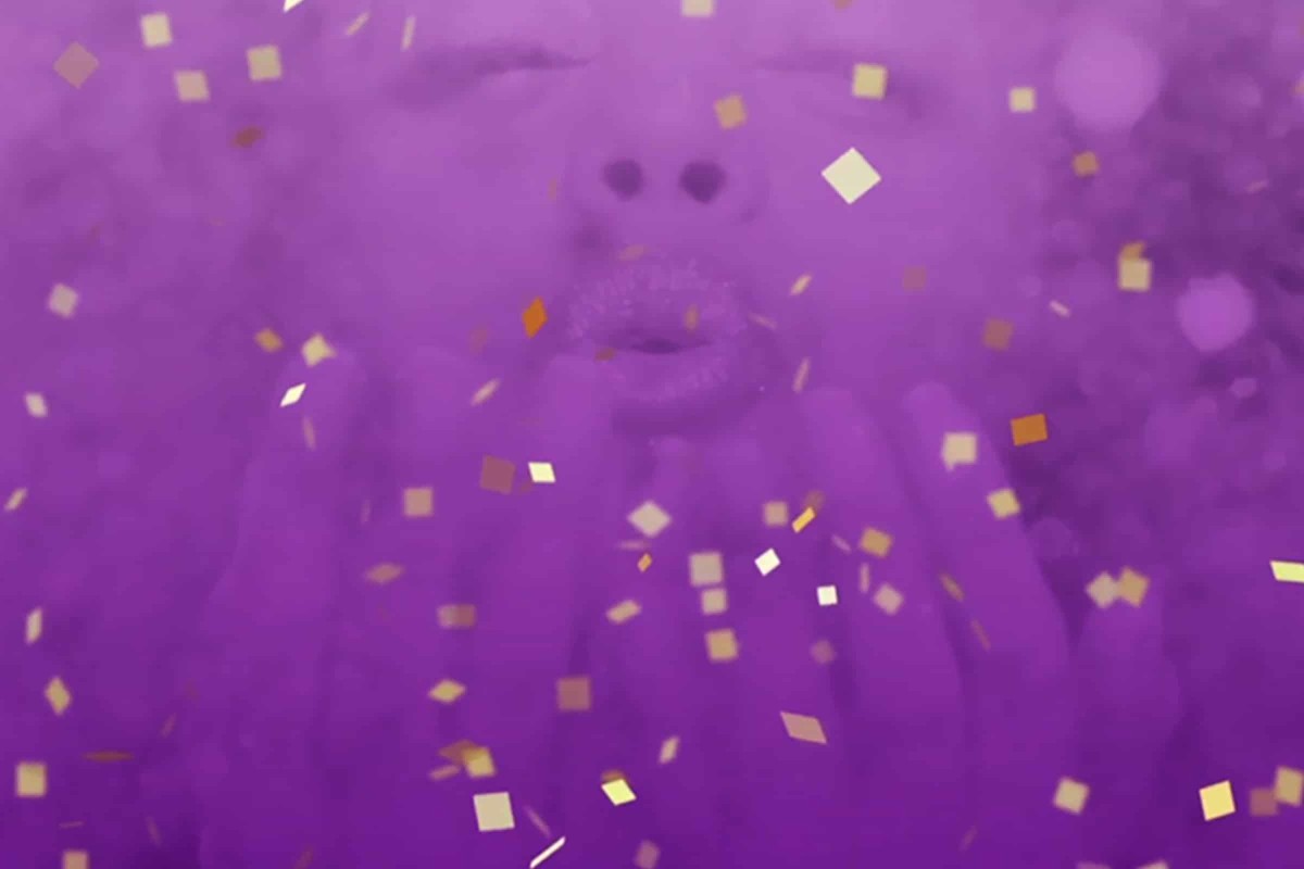 Stylized purple image of a woman blowing glitter