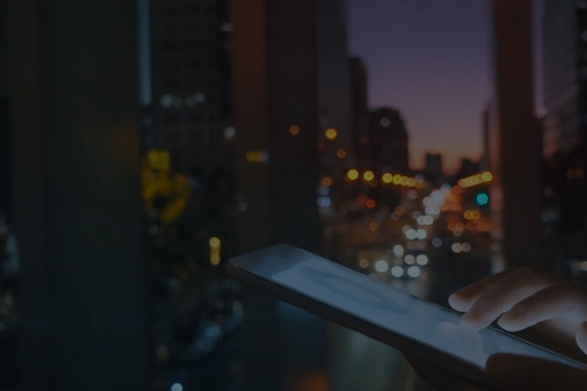 Tablet in front of a window with a nighttime cityscape