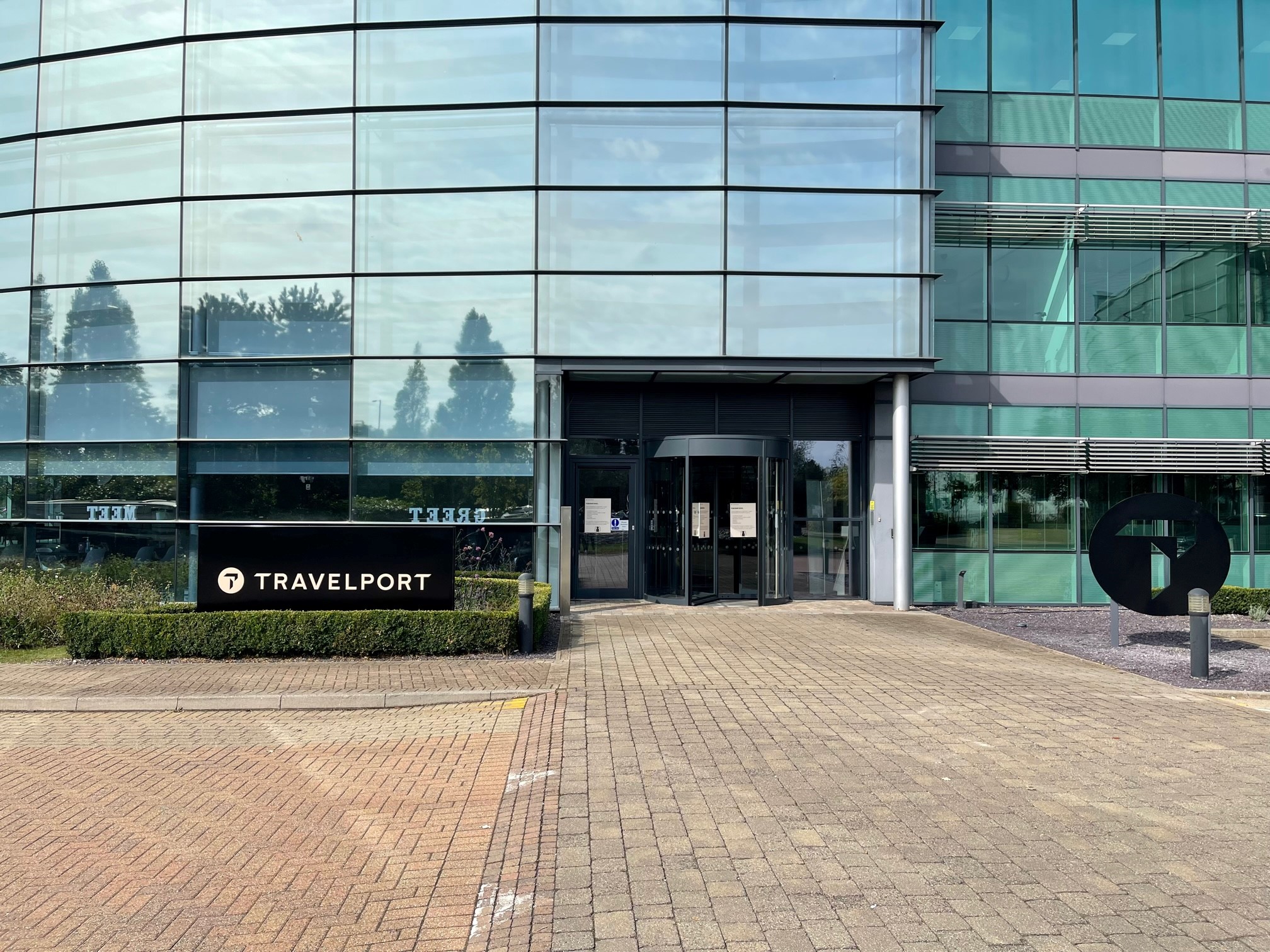 Travelport's Langley, U.K. office. An outside view of an office building with a Travelport sign.