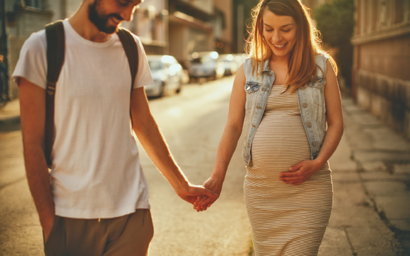 Man holding hands with pregnant women