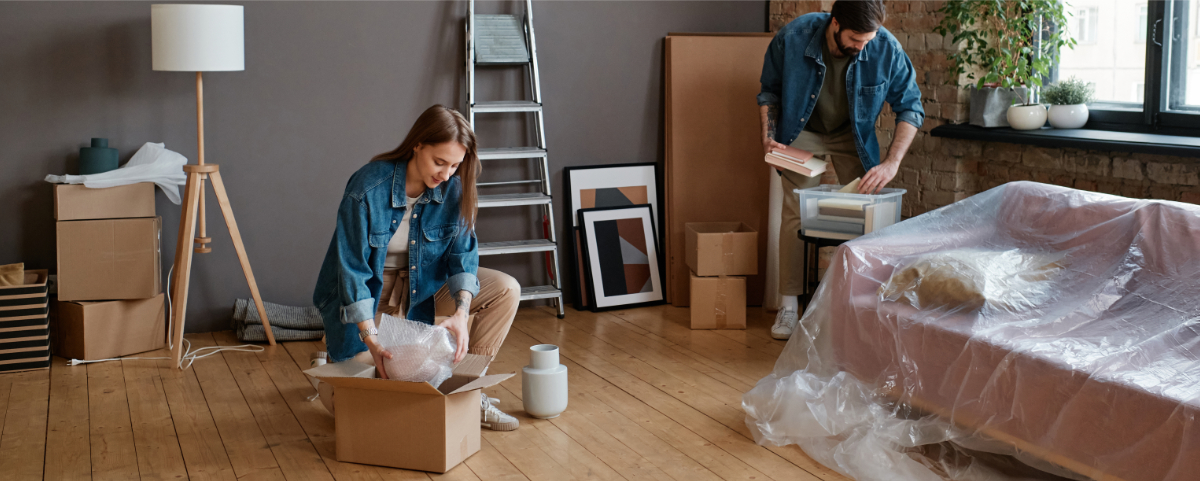A couple neatly packing away their living room