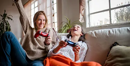Mother and daughter gaming on the sofa