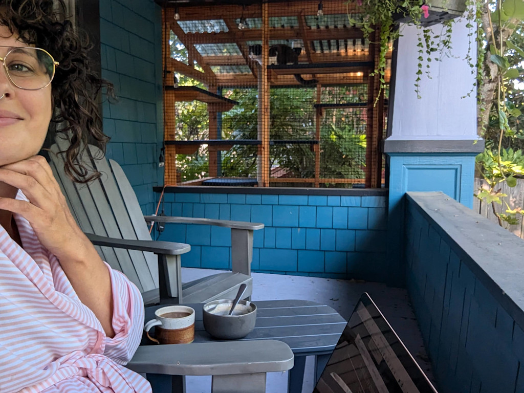 Janelle sits outside on the porch with Lyra.