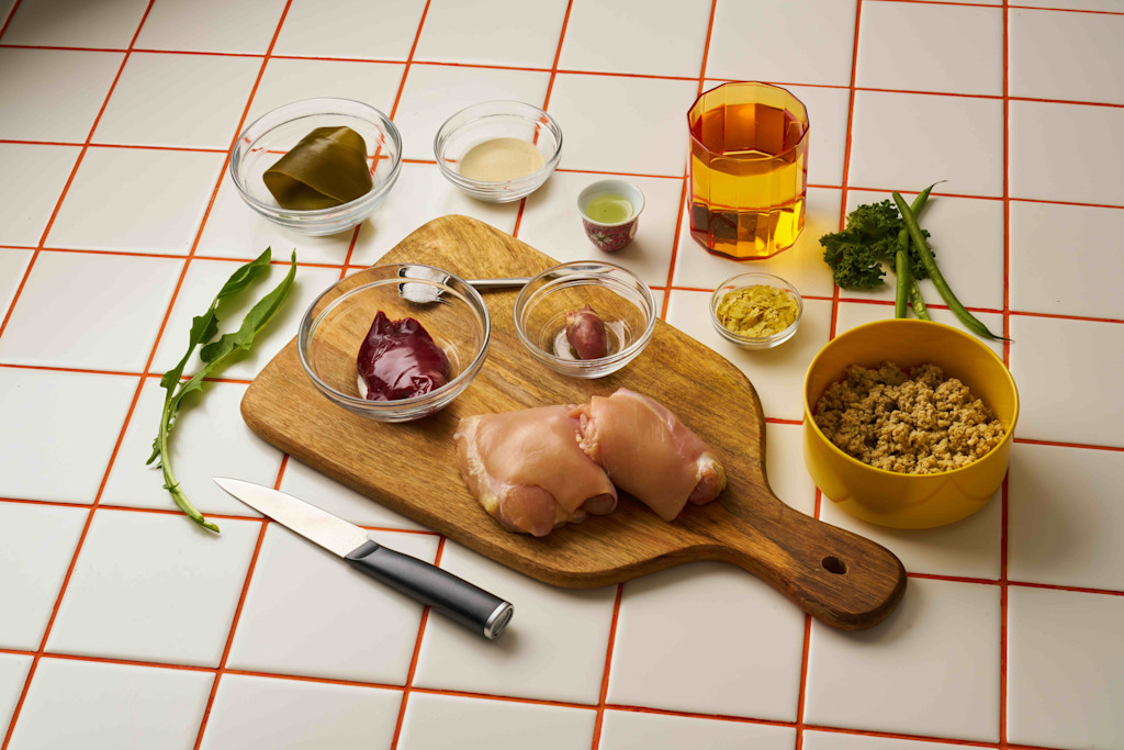 Flatlay of chicken, water, kale, and more.