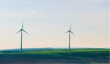 Wind turbines in green countryside land