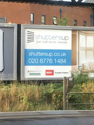 An outdoor billboard showing Trustpilot social proof for Shuttersup Offline Billboard Advertisement shuttersup.co.uk